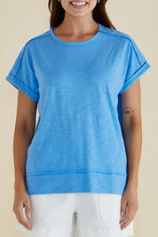 A model wearing the Shirley Cotton Short Sleeve Tee in colour Blue (Blue), from the front, cropped image