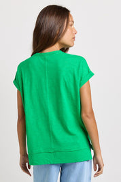 Model Genericm wearing size sample of the Shirley Short Sleeve Tee – Green in colour Green, from the back