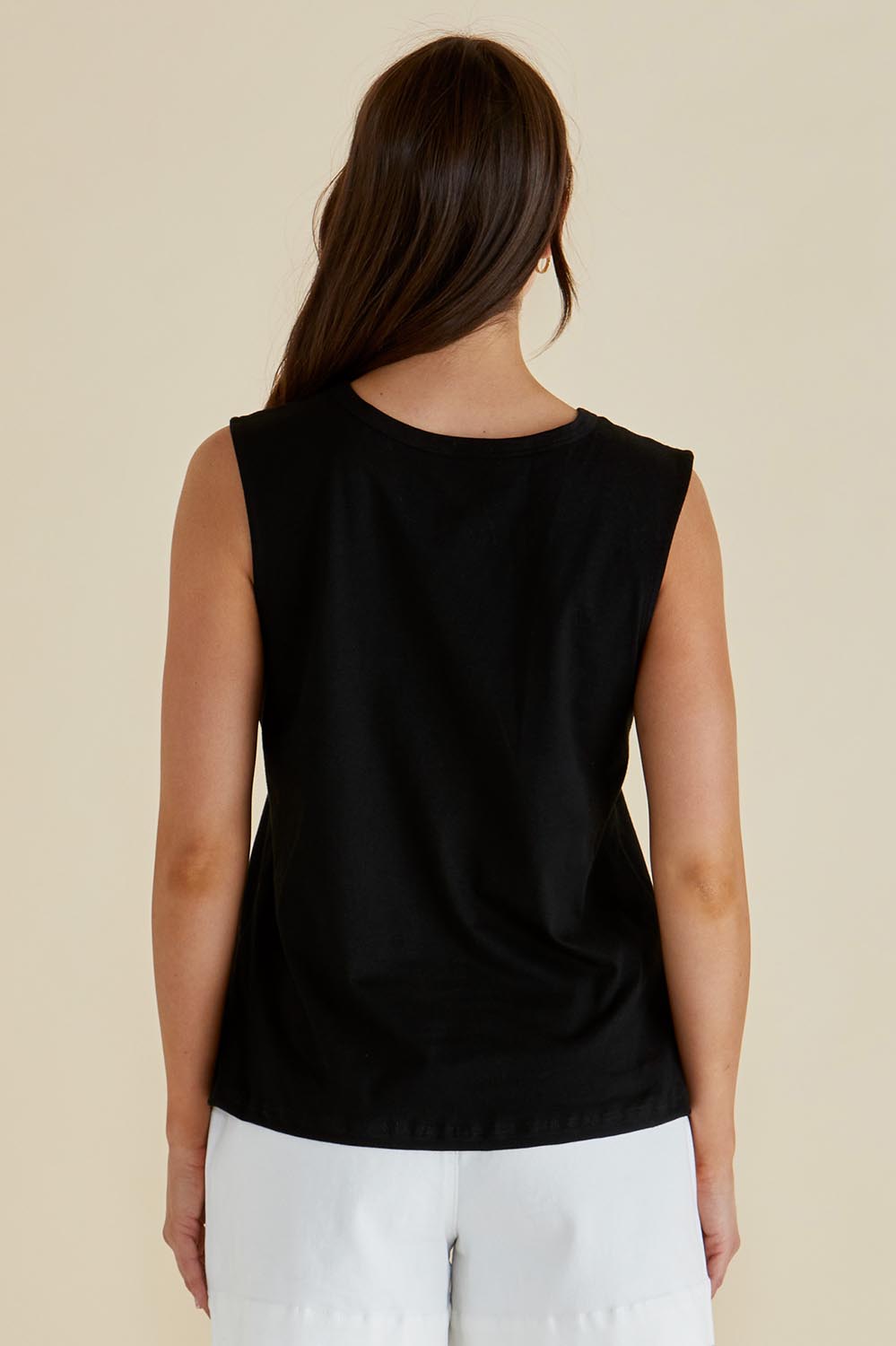 A model wearing the Jordyn Cotton Tank in colour Black (Black), from the back
