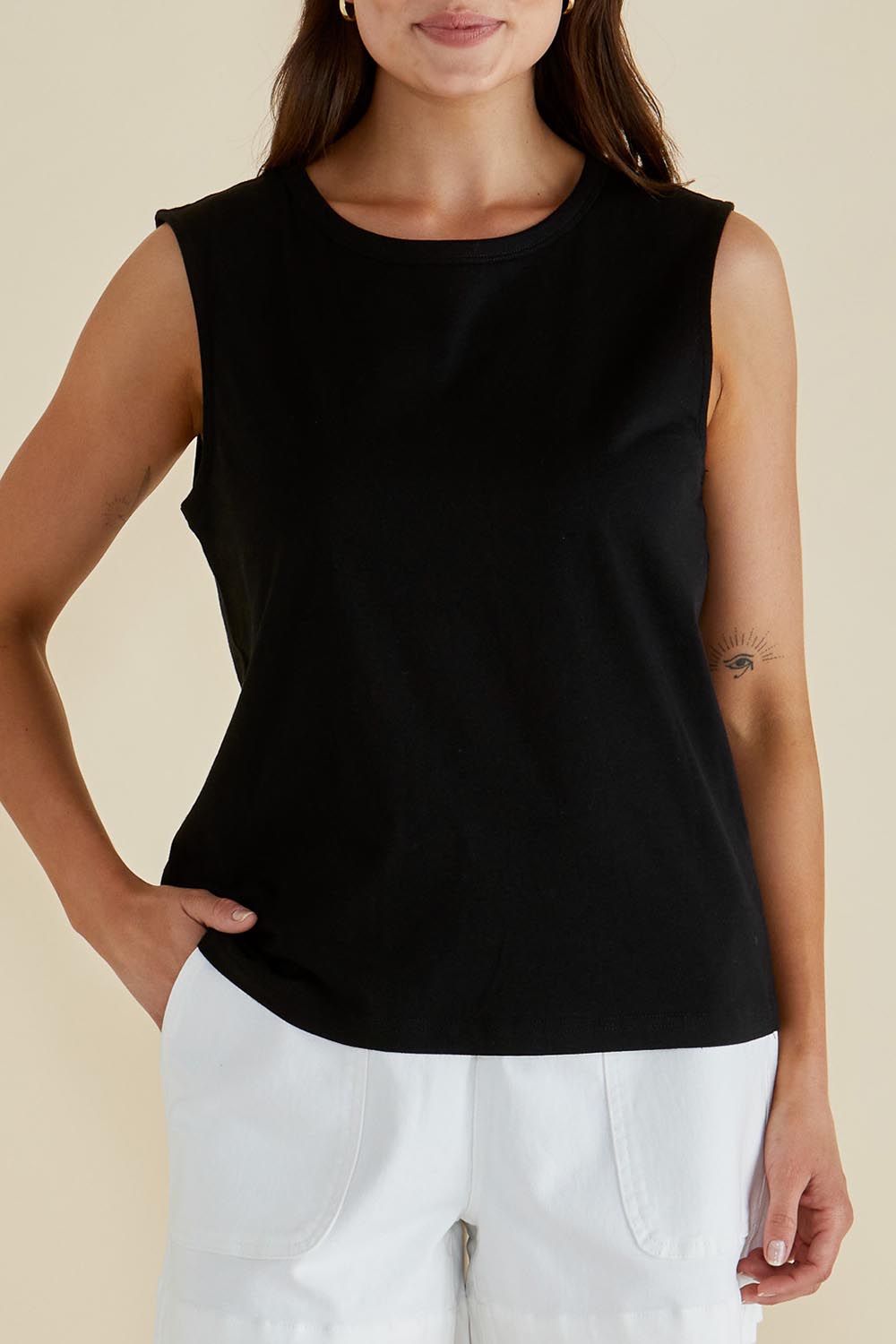 A model wearing the Jordyn Cotton Tank in colour Black (Black), from the front, cropped image
