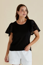 A model wearing the Lottie Embroidered Cotton Tee in colour Black (Black), from the front, cropped image