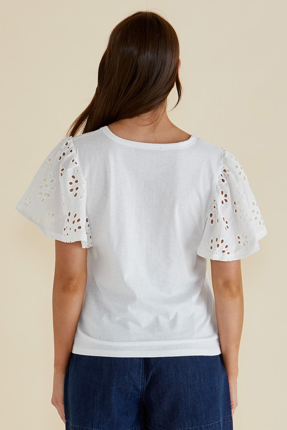 A model wearing the Lottie Embroidered Cotton Tee in colour White (White), from the back