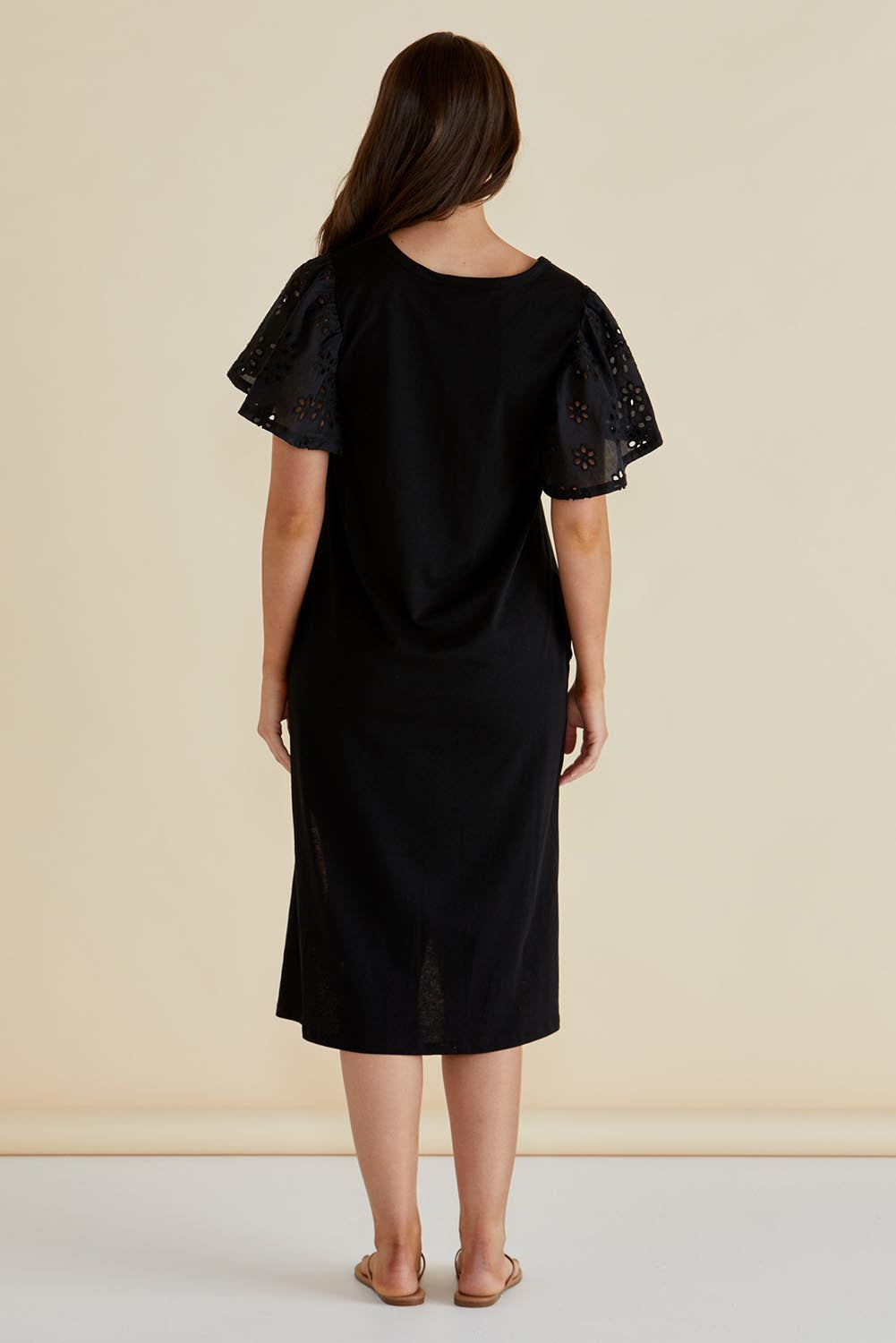 A model wearing the Sawyer Embroidered Cotton Dress in colour Black (Black), from the back