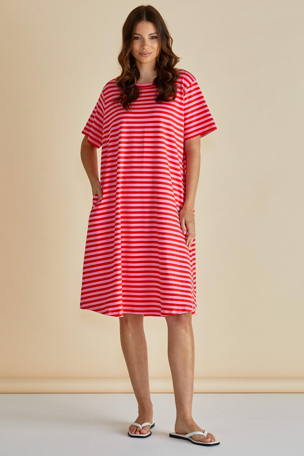 A model wearing the Eloise Cotton Tin colourShirt Dress - Pinkred (Red), from the front, showing the whole outfit