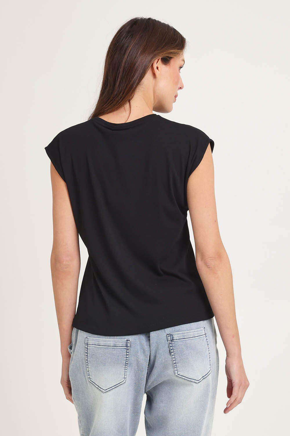 Model Madeline wearing size 10 of the Cuff Cotton Blend Rib Tee in colour Black (Black), from the back