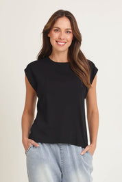 Model Madeline wearing size 10 of the Cuff Cotton Blend Rib Tee in colour Black (Black), from the front, cropped image
