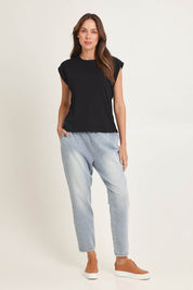 Model Madeline wearing size 10 of the Cuff Cotton Blend Rib Tee in colour Black (Black), from the front, showing the whole outfit