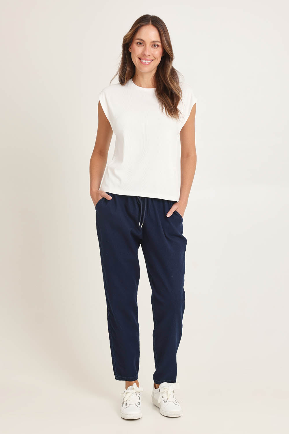 Model Madeline wearing size 10 of the Cuff Cotton Blend Rib Tee in colour White (White), from the front, showing the whole outfit