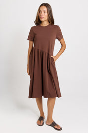 Model Genericm wearing size sample of the Ava Asymmetrical Dress – Chocolate in colour Chocolate, from the front