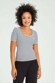 Model Olivia wearing size 10 of the Stacey Rib Tee in colour Whiteblack (White), from the front, cropped image