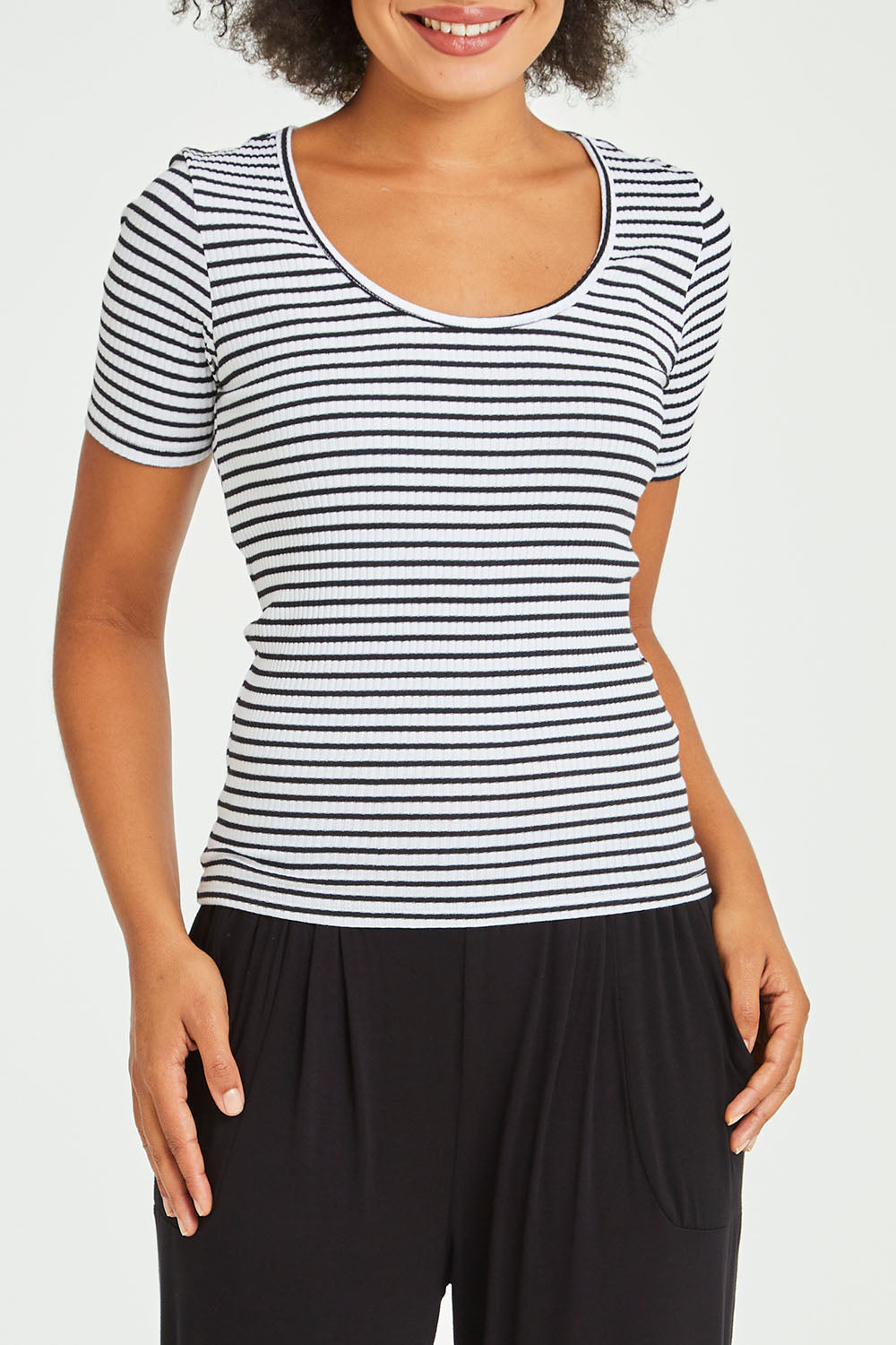 Model Olivia wearing size 10 of the Stacey Rib Tee in colour Whiteblack (White), from the front, cropped image