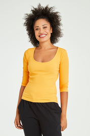 Model Olivia wearing size 10 of the Rosa 3/4 Rib Top in colour Mandarin, from the front, cropped image