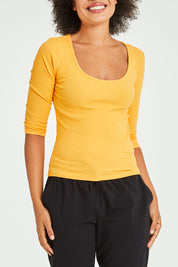 Model Olivia wearing size 10 of the Rosa 3/4 Rib Top in colour Mandarin, from the front, cropped image