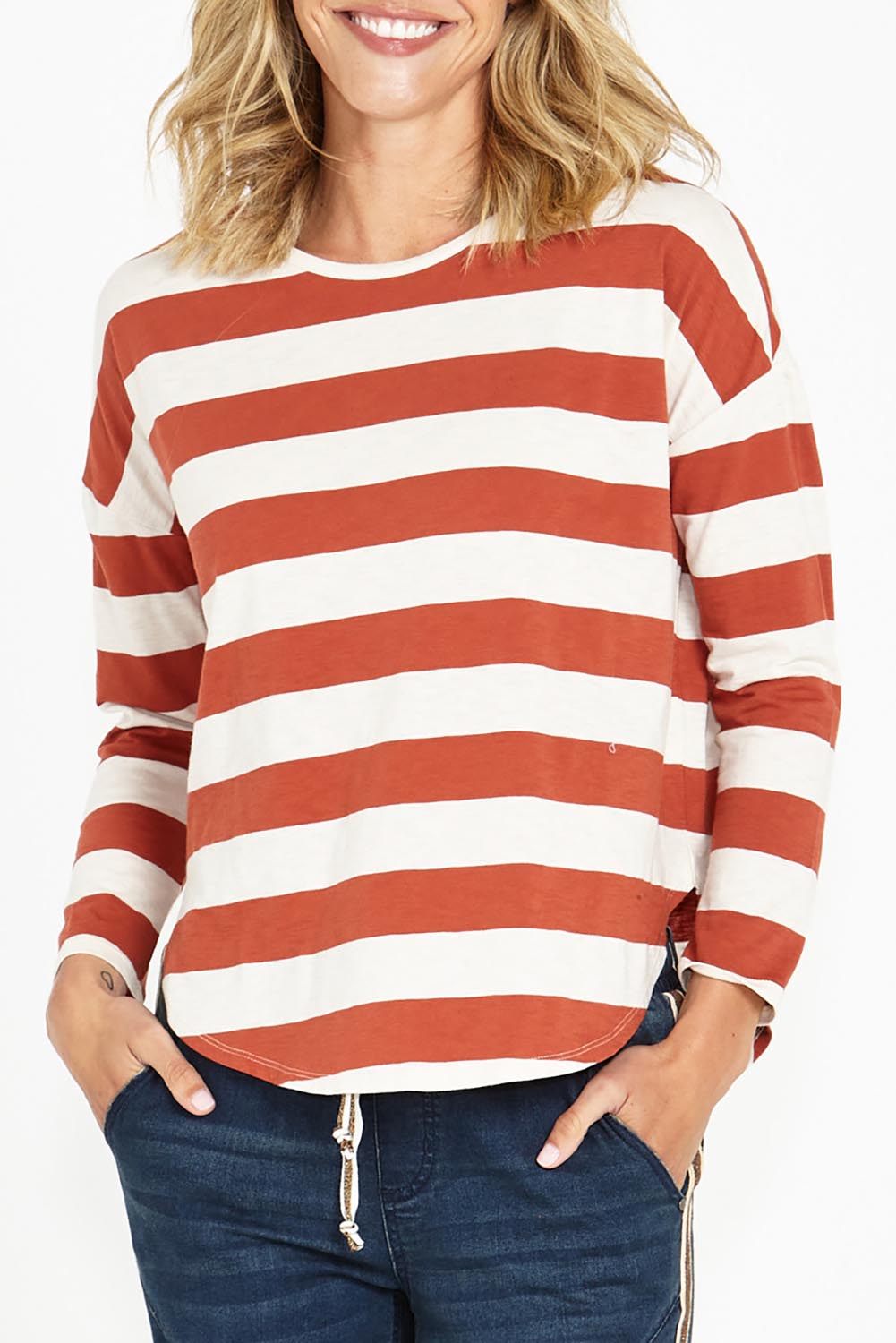 A model wearing the Jessie Long Sleeve Tee in colour Terracotta, from the front, cropped image