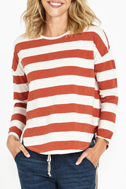 A model wearing the Jessie Long Sleeve Tee in colour Terracotta, from the front, cropped image