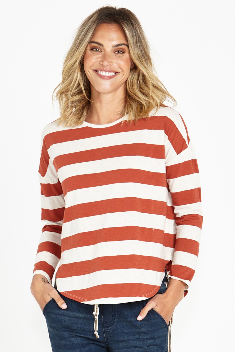 A model wearing the Jessie Long Sleeve Tee in colour Terracotta, from the front, cropped image