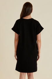 A model wearing the Elise V Neck Cotton Rib Dress in colour Black (Black), from the back