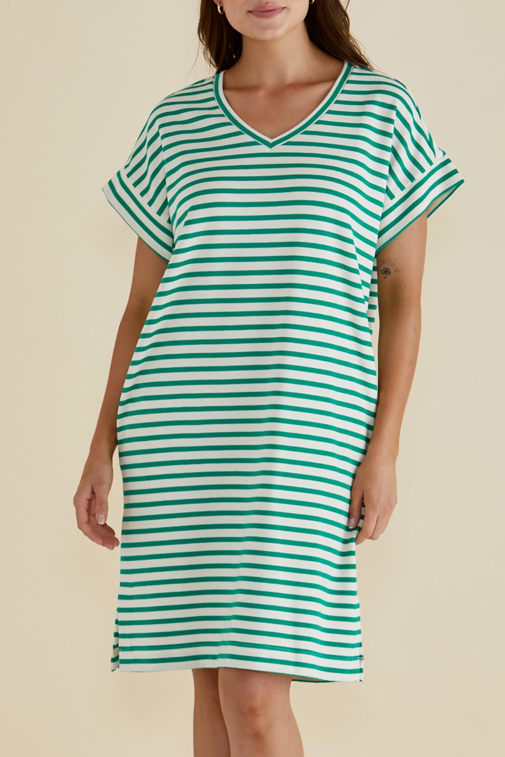 A model wearing the Elise V Neck Cotton Rib Dress in colour Green (Green), from the front, cropped image