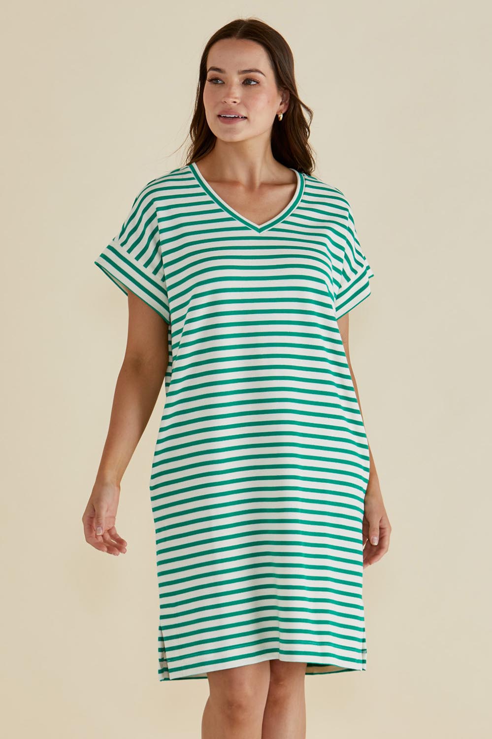 A model wearing the Elise V Neck Cotton Rib Dress in colour Green (Green), from the front, cropped image