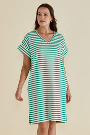 A model wearing the Elise V Neck Cotton Rib Dress in colour Green (Green), from the front, cropped image