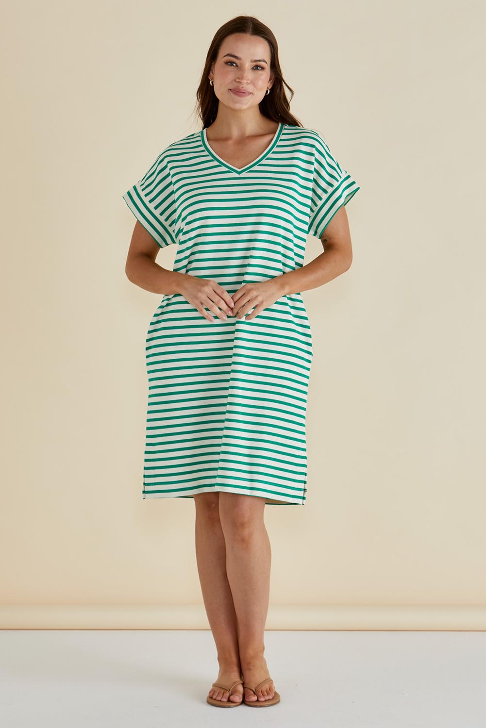 A model wearing the Elise V Neck Cotton Rib Dress in colour Green (Green), from the front, showing the whole outfit