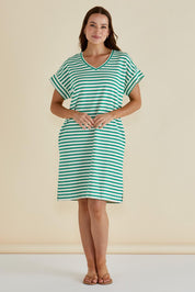 A model wearing the Elise V Neck Cotton Rib Dress in colour Green (Green), from the front, showing the whole outfit