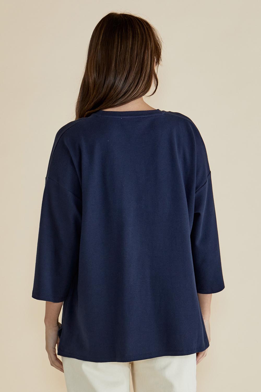A model wearing the Raven Cotton Top in colour Navy (Blue), from the back