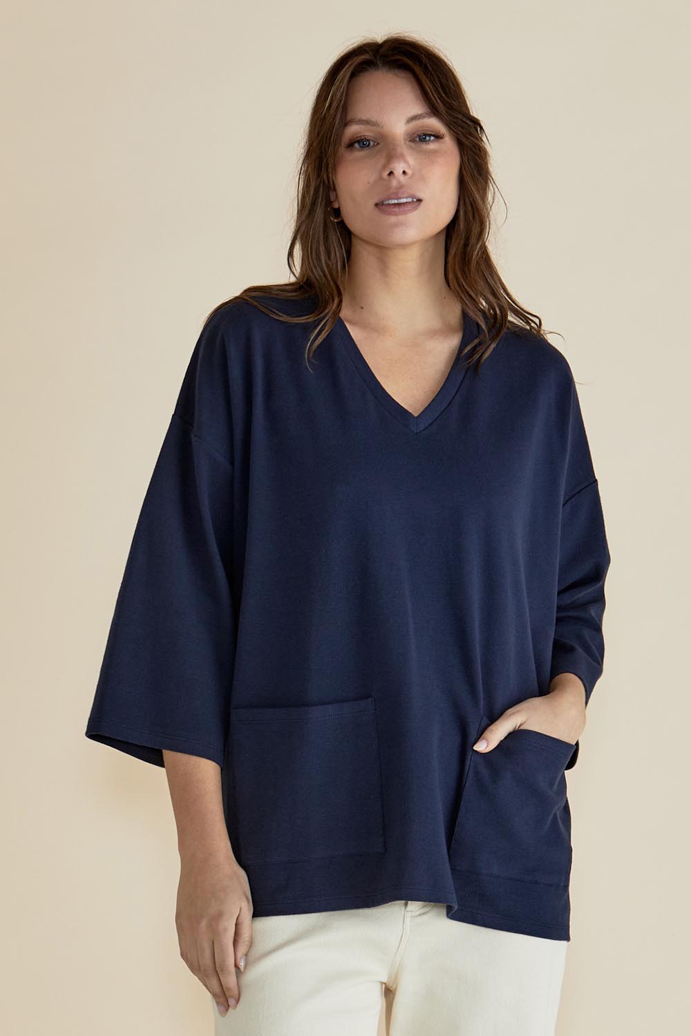 A model wearing the Raven Cotton Top in colour Navy (Blue), from the front, cropped image
