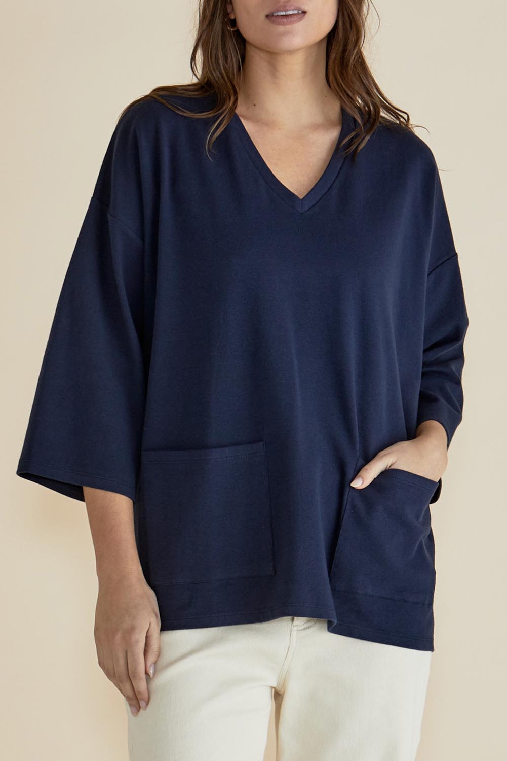 A model wearing the Raven Cotton Top in colour Navy (Blue), from the front, cropped image