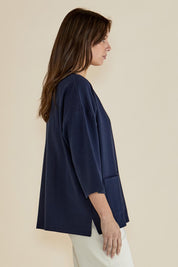 A model wearing the Raven Cotton Top in colour Navy (Blue), from the front, cropped image