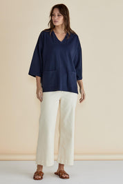 A model wearing the Raven Cotton Top in colour Navy (Blue), from the front, showing the whole outfit