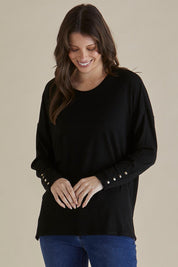 A model wearing the Hendrix Ribbed Long Sleeve Tee in colour Black (Black), from the front, cropped image