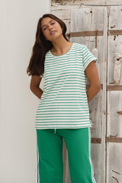 A model wearing the Caia Cotton Crew Tee in colour Grnstripe (Green), from the front, showing the whole outfit