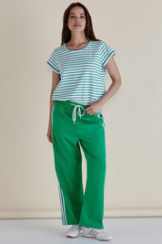 A model wearing the Nikki Relax Cotton Jogger in colour Green (Green), from the front, showing the whole outfit