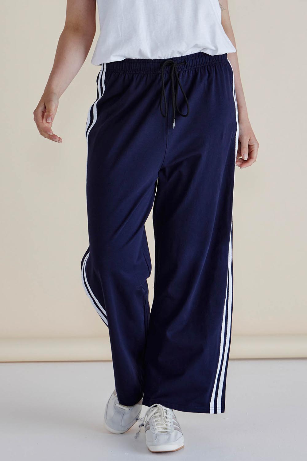 A model wearing the Nikki Relax Cotton Jogger in colour Navy (Blue), from the front, cropped image
