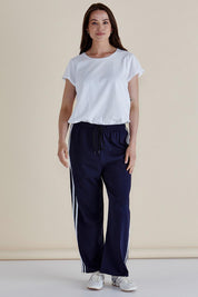A model wearing the Nikki Relax Cotton Jogger in colour Navy (Blue), from the front, showing the whole outfit