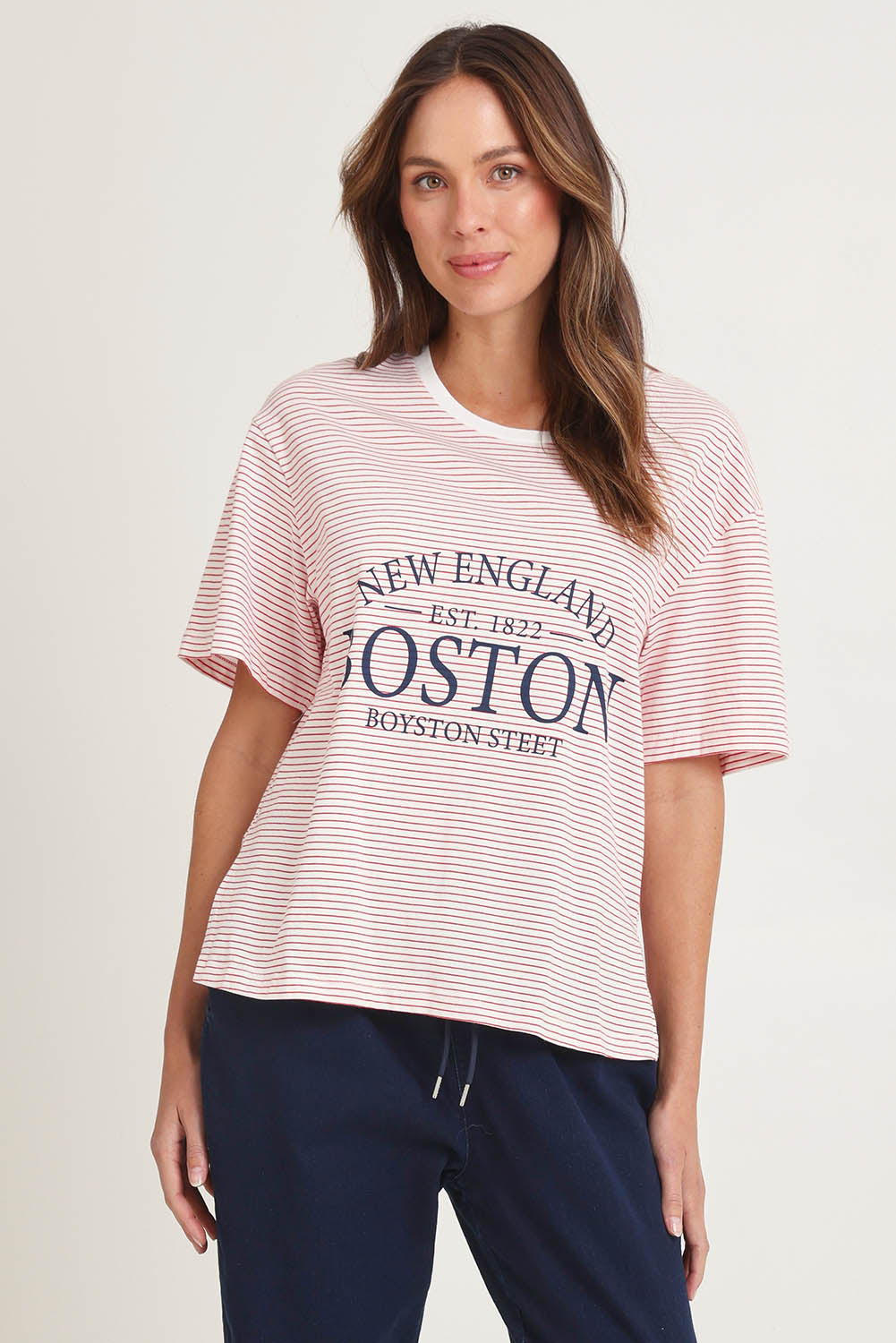 Model Madeline wearing size 10 of the Relax Boxy Cotton Tee in colour Boston (Red), from the front, cropped image