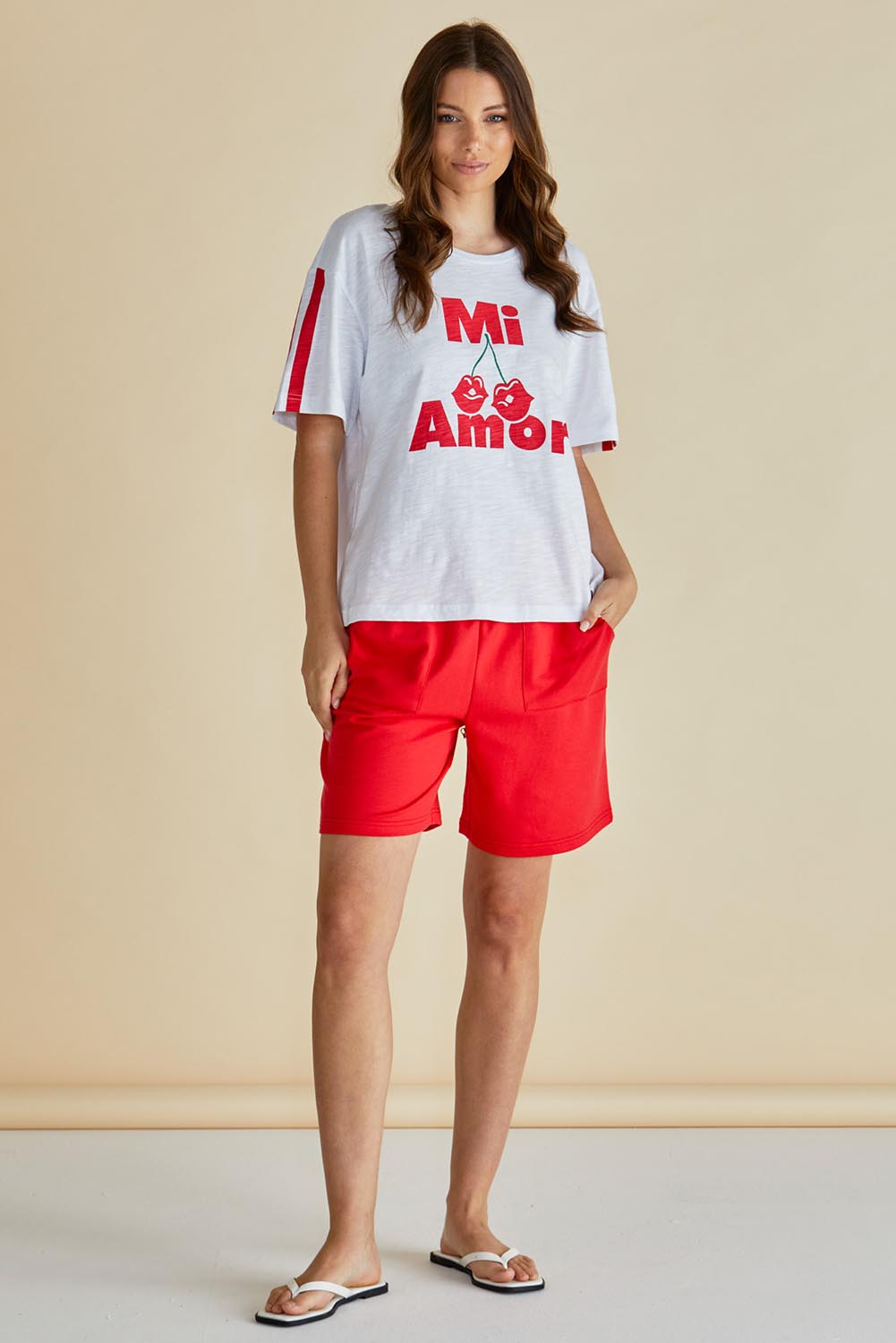 A model wearing the Relax Boxy Cotton Tee in colour Cherry (Red), from the front, showing the whole outfit