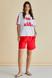 A model wearing the Relax Boxy Cotton Tee in colour Cherry (Red), from the front, showing the whole outfit