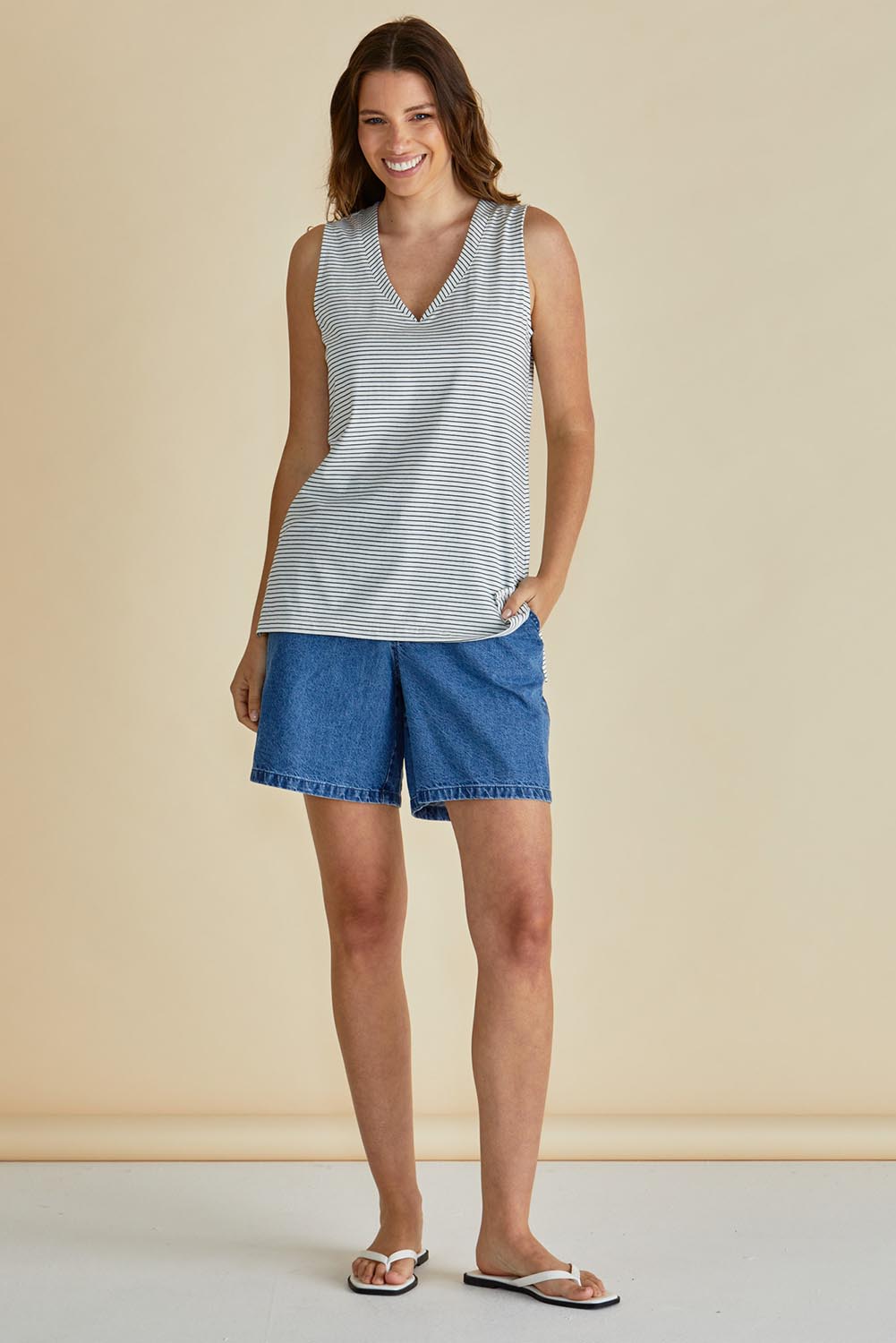A model wearing the Trinity Vin colourNeck Cotton Tank - Blkwhite, from the front, showing the whole outfit