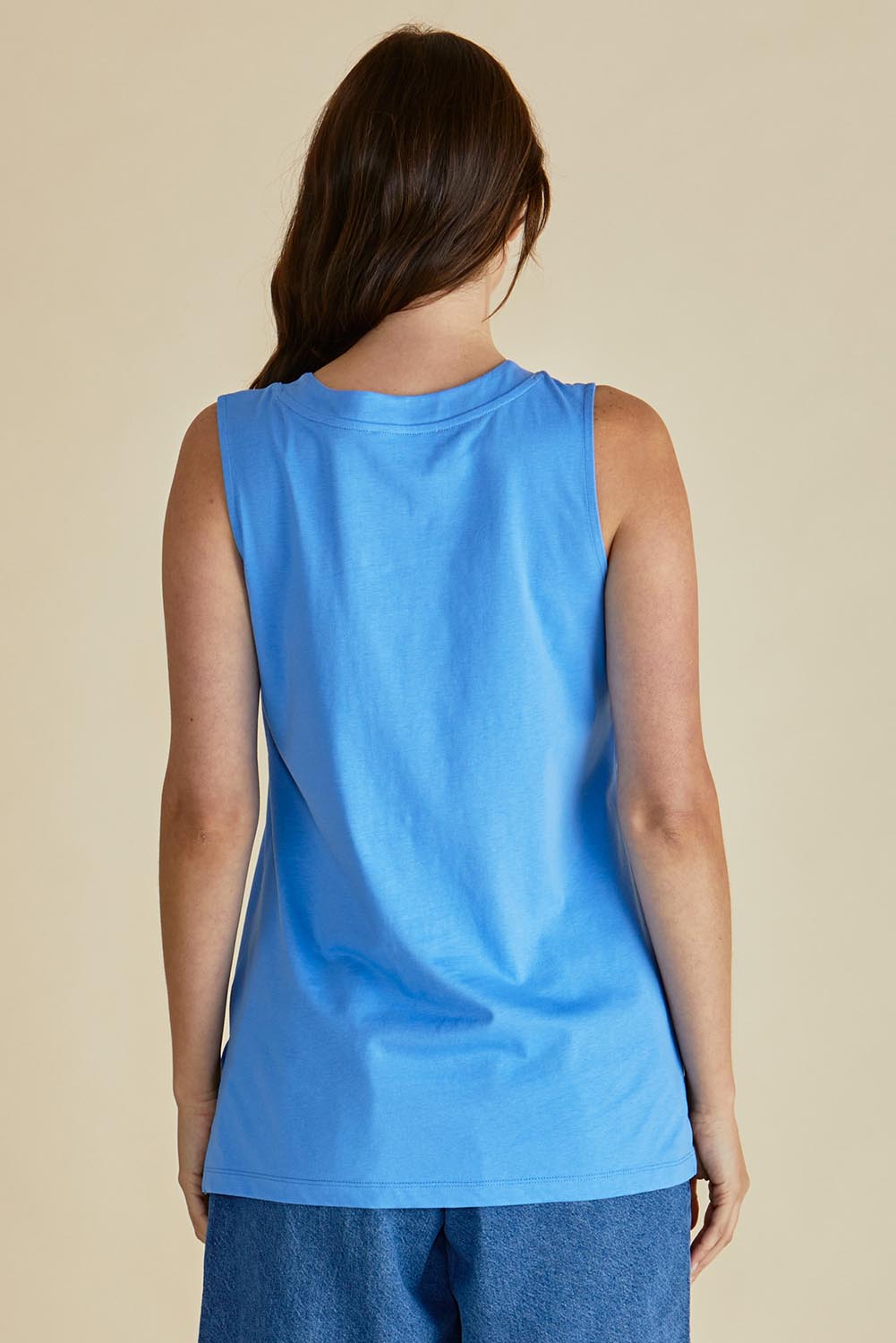 A model wearing the Trinity Vin colourNeck Cotton Tank - Powderblue (Blue), from the back