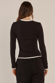 A model wearing the Cloud Tee in colour Black (Black), from the back