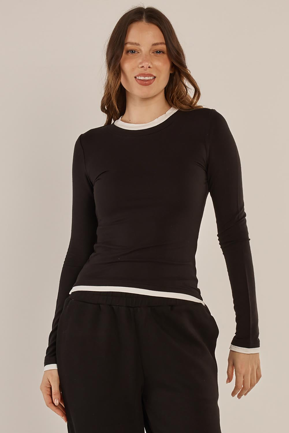 A model wearing the Cloud Tee in colour Black (Black), from the front, cropped image