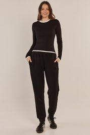 A model wearing the Cloud Tee in colour Black (Black), from the front, showing the whole outfit