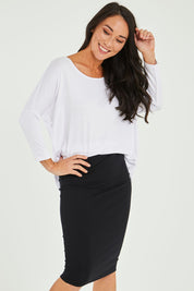 Model Katie wearing size 10 of the Alicia Midi Skirt in colour Black (Black), from the front, cropped image