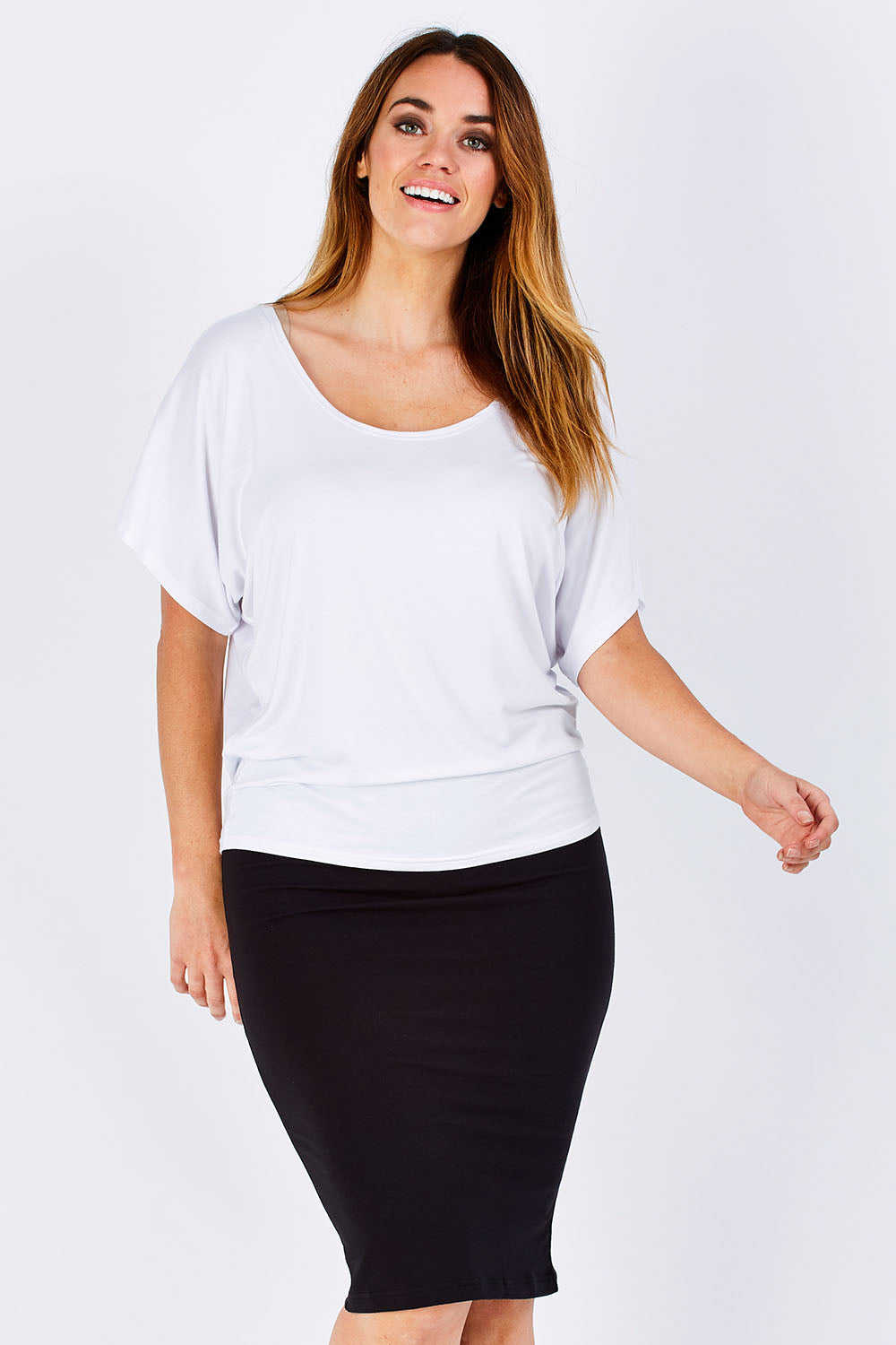 Model Laura wearing size 12 of the Alicia Midi Skirt in colour Black (Black), from the front, cropped image
