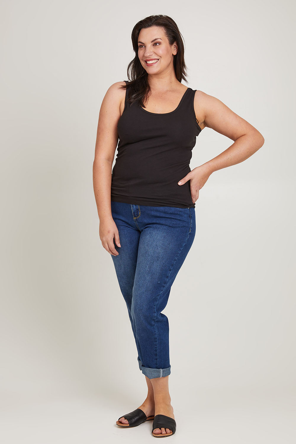 Model Poppy wearing size 16 of the Emma Cotton Scoop Tank in colour Black (Black), from the front, showing the whole outfit
