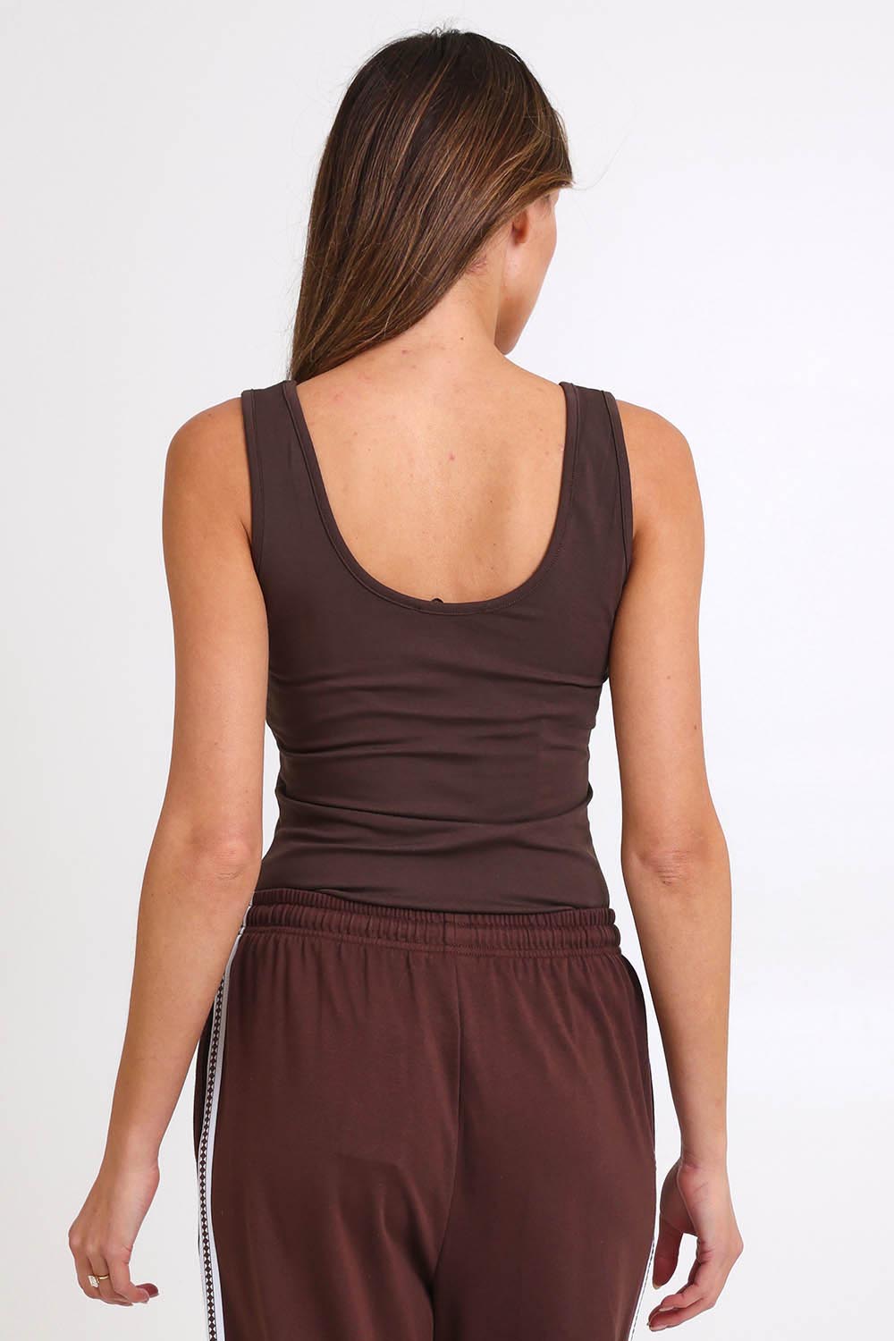 Model Madelinec wearing size 10 of the Emma Scoop Tank – Chocolate in colour Chocolate, from the back