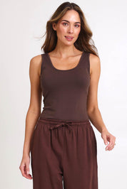 Model Madelinec wearing size 10 of the Emma Scoop Tank – Chocolate in colour Chocolate, in a cropped view