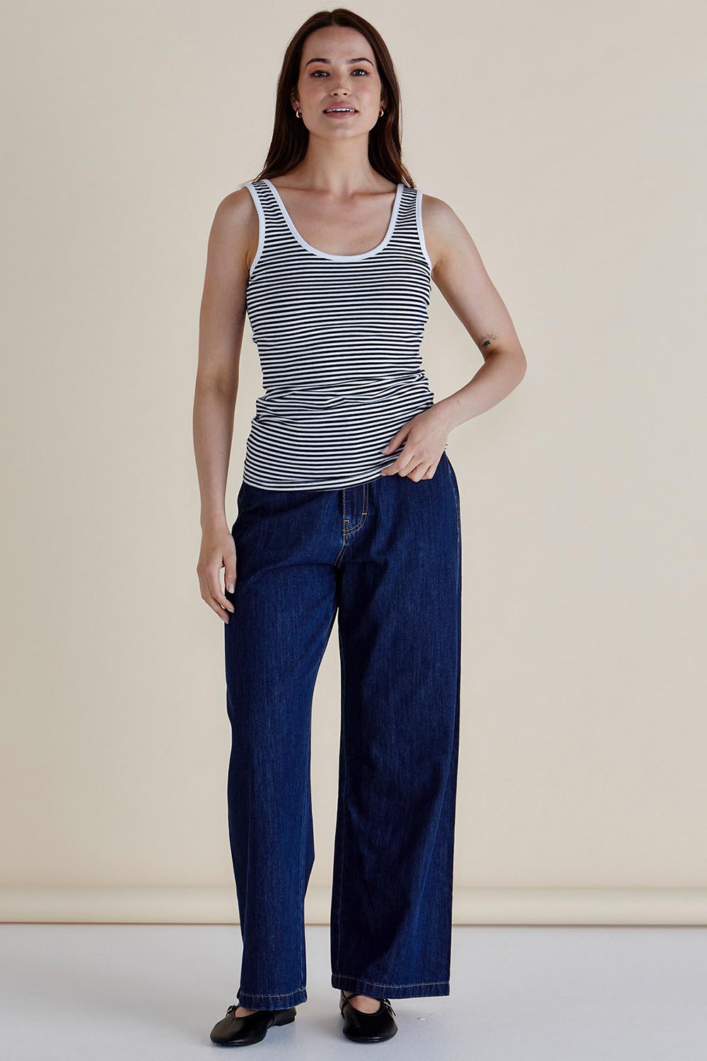 A model wearing the Emma Cotton Scoop Tank in colour NavyStripe (Blue), from the front, showing the whole outfit
